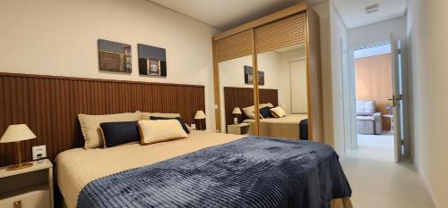 a bedroom with a large bed in a room at Dream Apartment-Rooftop, Pool, Mountain & Sea View in Capão da Canoa