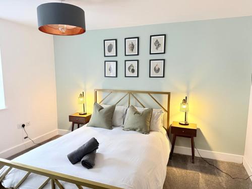 a bedroom with a large white bed with two lamps at Orchard Point in Southampton