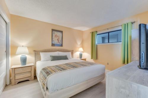 a bedroom with a bed and a window and a television at 0709 Seaside Serenade by Atlantic Towers in Carolina Beach