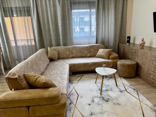 a living room with a couch and a table at Ardbay Apartment in Golem