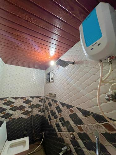 a bathroom with a shower and a bed in it at hotel Atithii in Rīngas