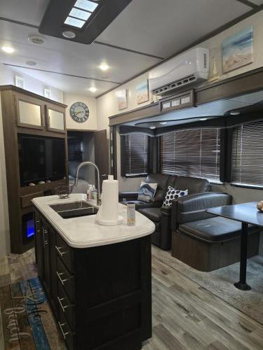 a kitchen and living room in an rv at Courtside Villa at Key Largo in Key Largo