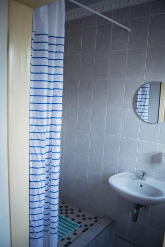 a white bathroom with a sink and a shower at Bernliz Guest House in Bokong