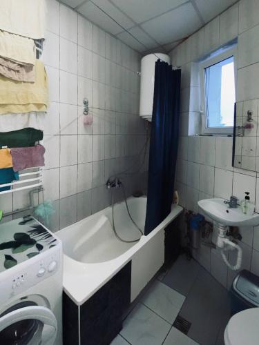 a bathroom with a bath tub and a sink at New York Hostel in Lviv