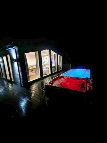 a small house with a pool in the dark at Finest Retreats - Silverwood Executive Chalet in Errol