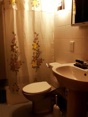 a bathroom with a toilet and a sink at SEAFRONT I Pretty Bay Apartments in Birżebbuġa
