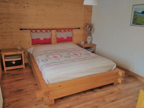 a bedroom with a bed in a log cabin at ferme des grands blaise in La Bresse