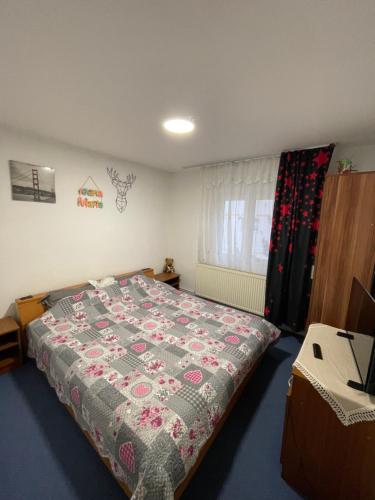 a bedroom with a bed with a quilt on it at Apartament 28 noiembrie Ap 8 Et 2 in Siret
