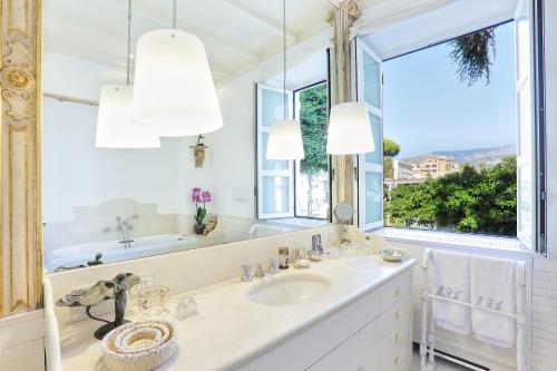 a bathroom with a sink and a mirror at Villa Lalen Sorrento Private Luxury Residence with Garden, Terrace & Jacuzzi in Sorrento