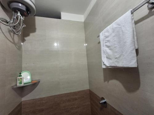 a bathroom with a towel hanging from a window at Vamika Palace in Ayodhya