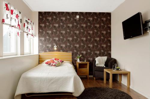 Кровать или кровати в номере Hotell City