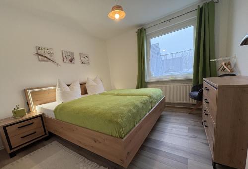 a bedroom with a large bed and a window at Ferienhaus Edda in Timmendorfer Strand