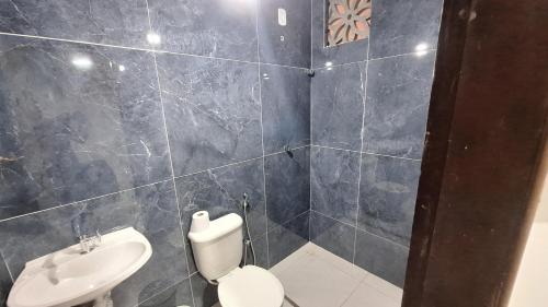 a bathroom with a toilet and a sink at Mirante Rota do Mar in Maceió
