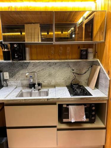 a small kitchen with a sink and a stove at NATU Visconde de Mauá in Itatiaia