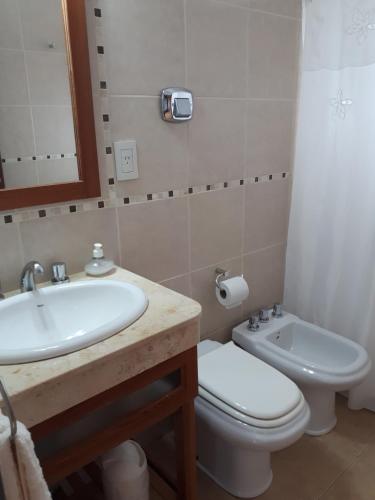 a bathroom with a sink and a toilet and a mirror at Alfonsina 2 in Colón