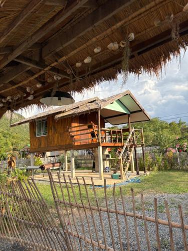 a small building with a playground with a house at ริมบึงโฮมสเตย์ in Ban Phu Noi