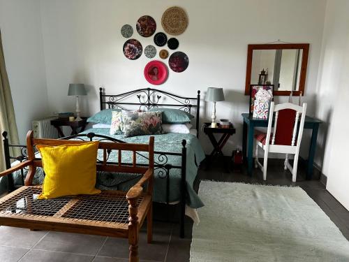 a bedroom with a bed and plates on the wall at The Keep Cottage in Underberg