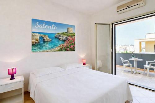 a bedroom with a bed and a view of the ocean at Residence Ionian Gallipoli in Gallipoli