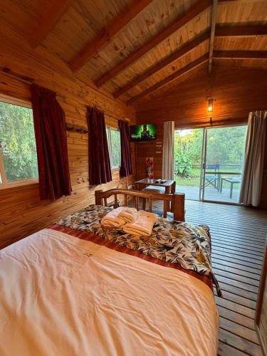 a bedroom with a large bed in a cabin at Rio Manso Tigre in Tigre
