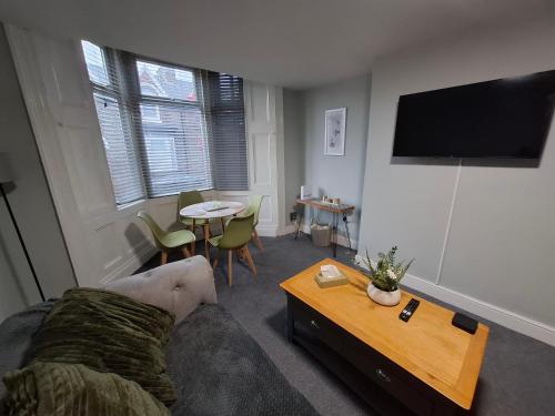 a living room with a couch and a table at Alice house in Sunderland