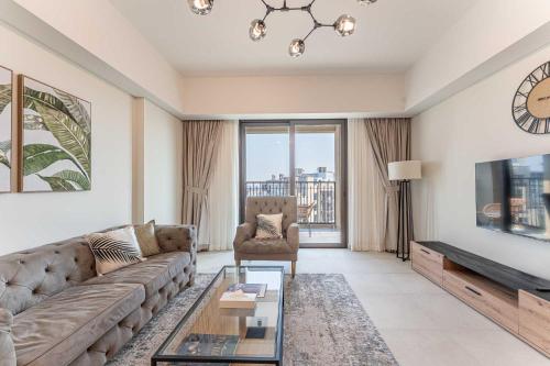 a living room with a couch and a tv at HAVN - 1 bedroom in Madinat Jumeirah Living in Dubai