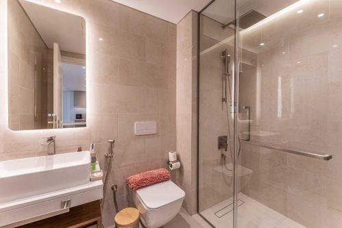 a bathroom with a shower and a toilet and a sink at HAVN - 1 bedroom in Madinat Jumeirah Living in Dubai