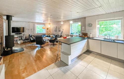 a large kitchen and living room with a counter top at Nice Home In Højby With Sauna in Højby