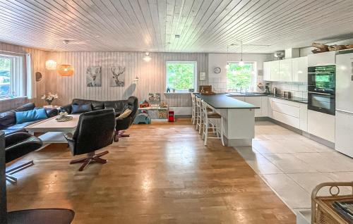 a kitchen and living room with a couch and a table at Nice Home In Højby With Sauna in Højby