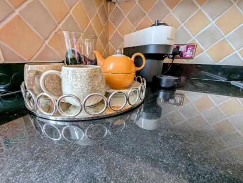 a counter top with a coffee maker and a tea pot at City Center Gem-4Bd House! in Edinburgh