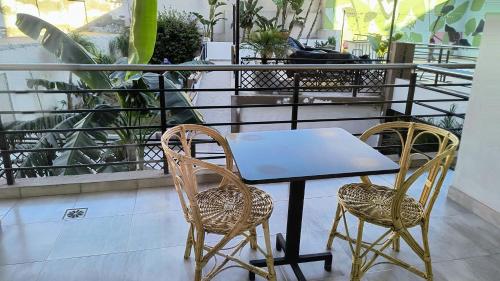 a table and two chairs on a balcony at HDA Miraflores in Termas de Río Hondo