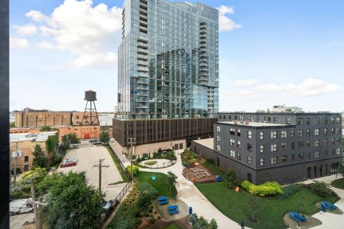 an aerial view of a tall building in a city at Envitae Hotel 4BR Modern Sleek Apartment in Chicago