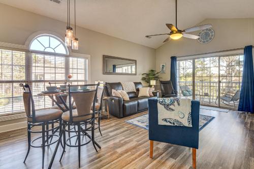 a living room with a couch and a table at Golf, Gamble and Fish! Condo with Pool in Little River in Little River