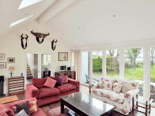 a living room with a couch and a table at Cliff Cottage in Port Appin