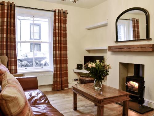 a living room with a couch and a fireplace at Gilbert's Warrant in Keswick