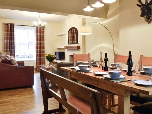 a dining room with a wooden table with chairs at Gilbert's Warrant in Keswick