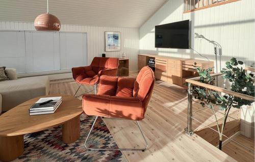 a living room with a couch and a table at Amazing Home In Juelsminde With House Sea View in Juelsminde