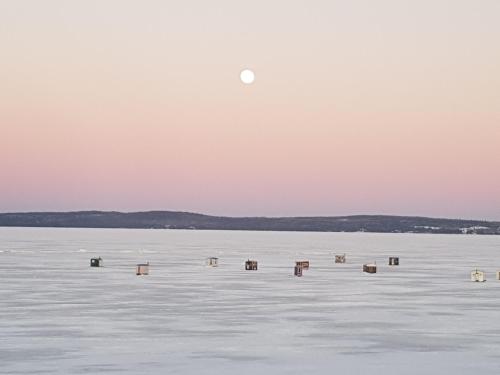 a moon rising over a large body of water at Haileybury Beach Motel in Haileybury