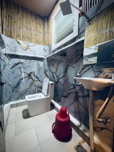 a bathroom with a toilet and a sink at The Exotic Aura Resort in Pondicherry