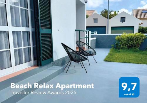 two chairs sitting on a patio in front of a house at Beach Relax Apartment in Porto Santo