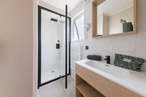 a bathroom with a sink and a shower at Camping maeva Respire de La Croze in Châtel-Guyon