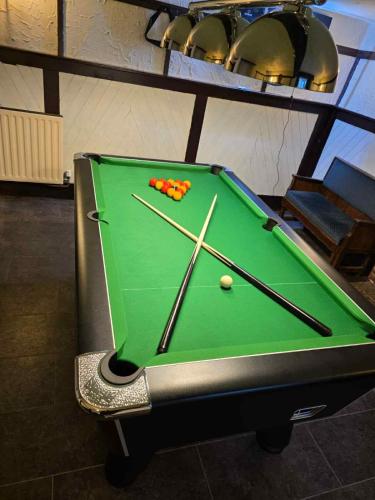 a pool table with balls on top of it at Ye Olde Bowling Green Inn in Bradwell