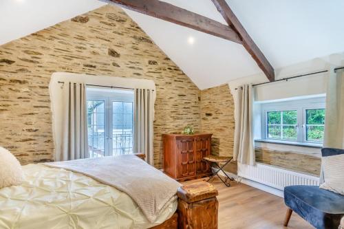 a bedroom with a bed and a brick wall at 3 Bed in Yeolmbridge oc-t30293 in Werrington