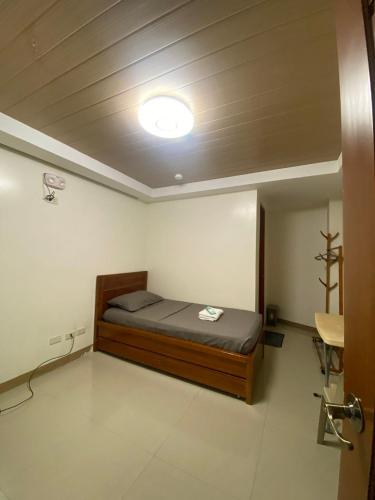 a bedroom with a bed and a light on the ceiling at Hotel Marinduque in Boac