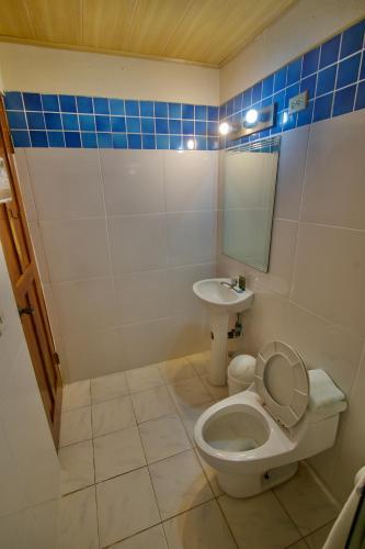 a bathroom with a toilet and a sink at Hotel Sol y Mar in Santa Catalina