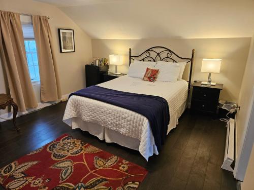 a bedroom with a large bed and two night stands at Come As You Are Inn LLC in Sayville