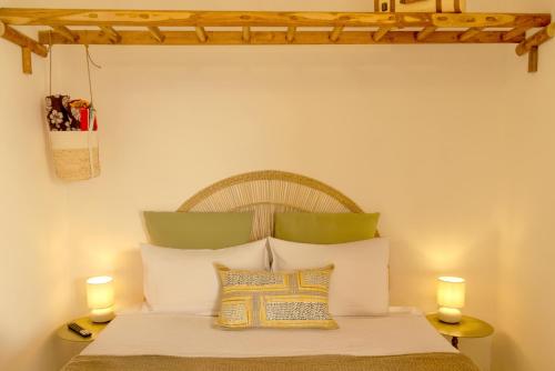 a bedroom with a bed with two candles on two tables at CAMASUD 3 L'ATTICO Nardò in Nardò