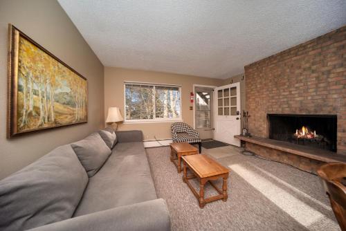 a living room with a couch and a fireplace at Hi Country Haus Unit 0309 in Winter Park