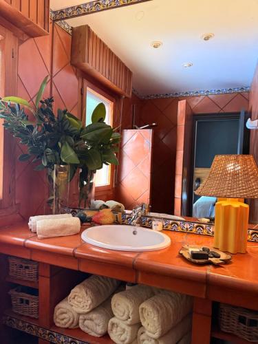 a bathroom with a sink and a large mirror at La Lagartija Adults Only in Ajo