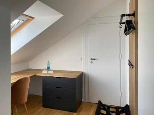 an attic office with a desk and a chair at Backbord Geesthacht in Geesthacht