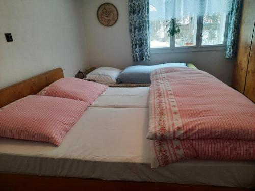 a bedroom with two beds with pillows on them at Chalupa u Josefa in Valašská Polanka